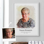 Watercolor-style memorial portrait of an older woman in glasses, in a white frame, beside the reference photo it came from