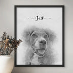 Sketch-style portrait of a dog with its mouth open, named Jack, in a black frame beside a vase of dried flowers