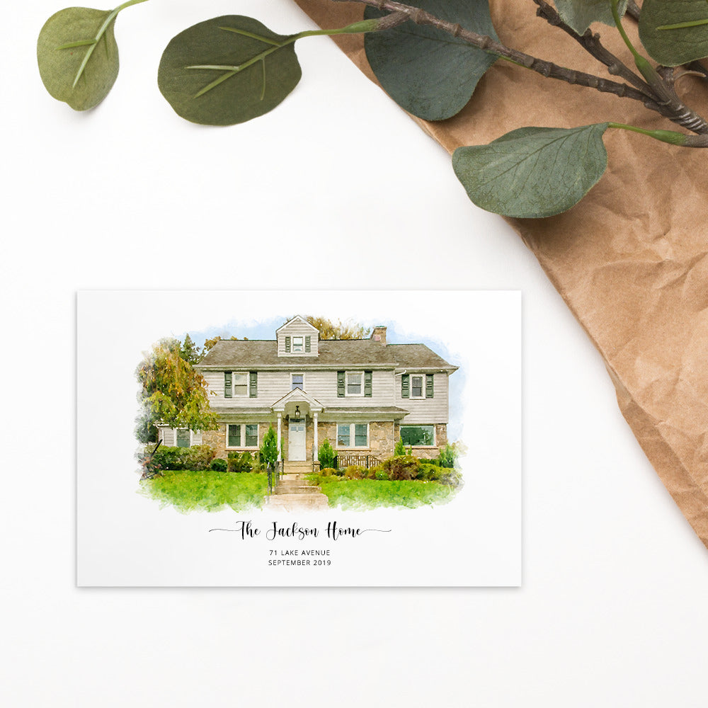 Postcard printed with a watercolor-style portrait of a house, titled 'The Jackson Home', beside green leaves