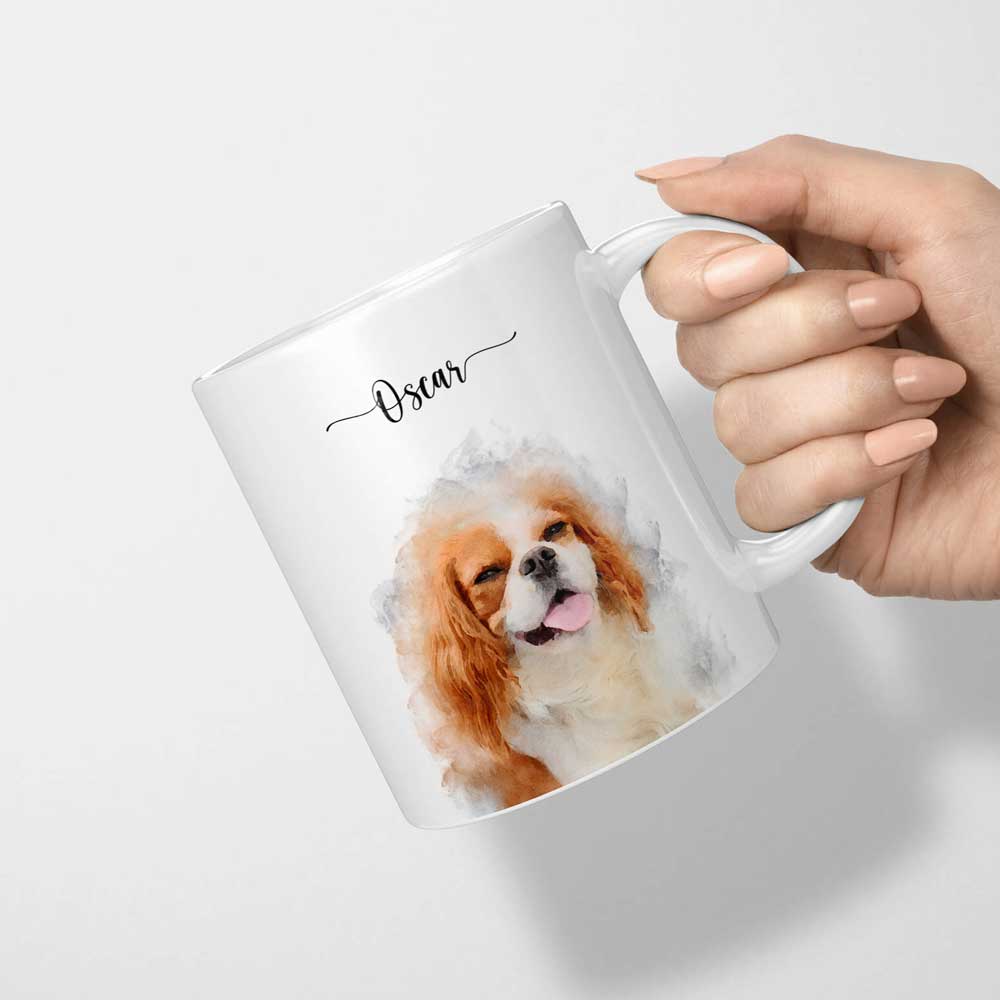 White mug held by the handle, printed with a watercolor-style portrait of a brown-and-white dog and the name 'Oscar'